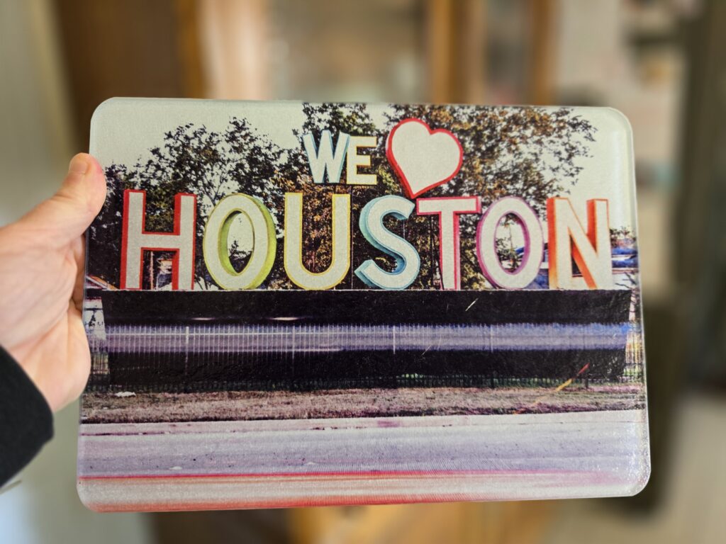 Glass cutting board with "We Love Houston" art installation photo