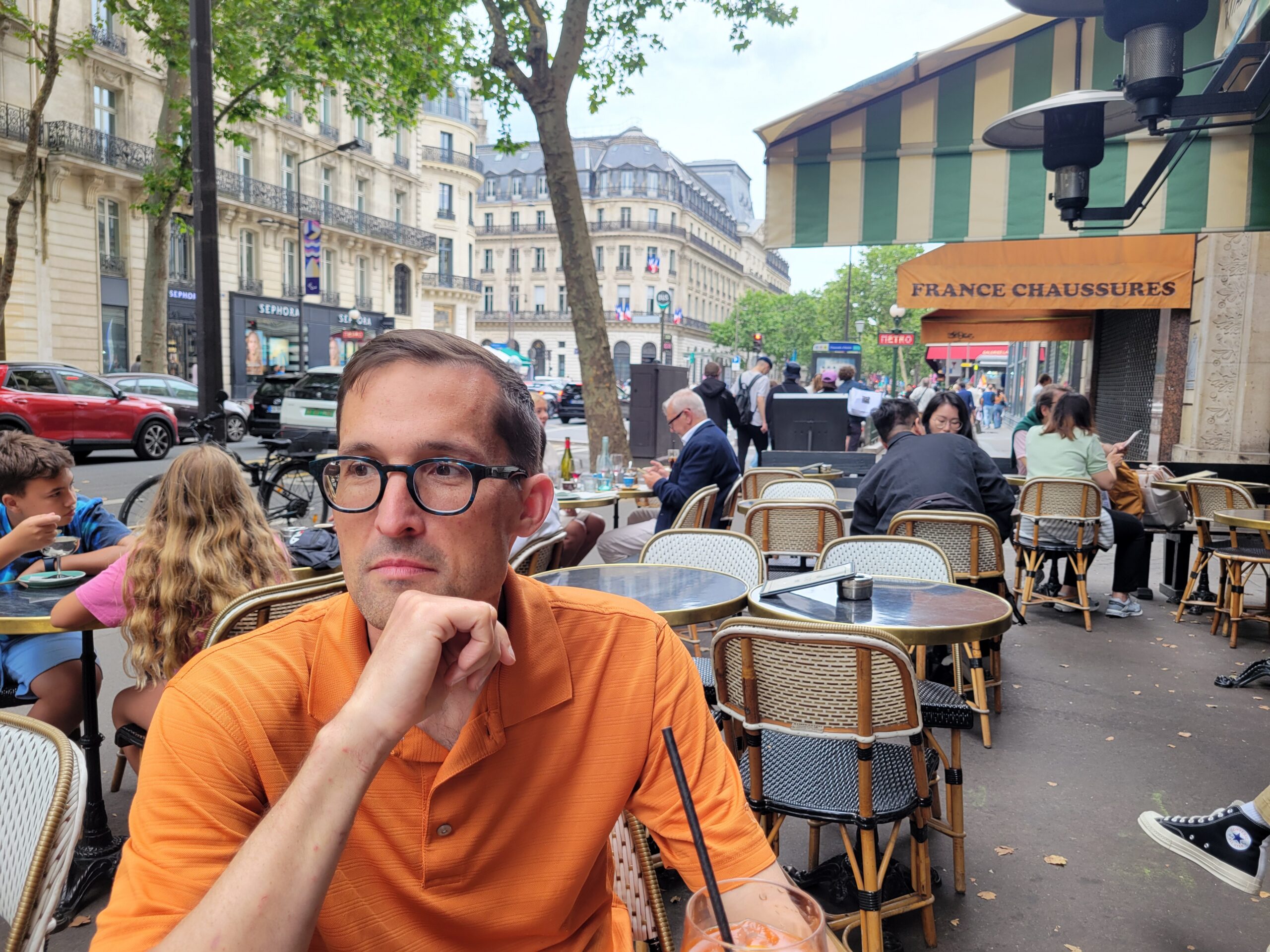 Man at a cafe staring thoughtfully